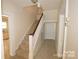 Carpeted staircase with wood handrail leading to the second floor of the home at 309 S Greene St, Wadesboro, NC 28170