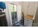 Utility room with storage cabinet, hot water heater, and access to the outdoors at 309 S Greene St, Wadesboro, NC 28170