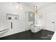 Contemporary bathroom with soaking tub, shower, and dark tile floors at 3119 Shenandoah Ave, Charlotte, NC 28205