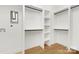 Bright, white walk-in closet with wooden floors and built-in shelving and hanging racks at 3119 Shenandoah Ave, Charlotte, NC 28205