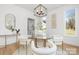 Bright dining area with modern chandelier, glass table and stylish chairs at 3119 Shenandoah Ave, Charlotte, NC 28205