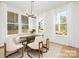 Elegant dining room with large windows, neutral decor, and stylish chandelier, perfect for Gathering gatherings at 3119 Shenandoah Ave, Charlotte, NC 28205