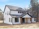 New construction two-story home with white siding, black trim, a gabled roof, and natural wood porch posts at 3119 Shenandoah Ave, Charlotte, NC 28205