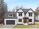 Stunning two-story home with a modern black-and-white design, gray roof, and beautifully landscaped front yard at 3119 Shenandoah Ave, Charlotte, NC 28205