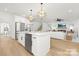 Open-concept kitchen with a large island, stainless steel appliances, and seamless flow into the living area at 3119 Shenandoah Ave, Charlotte, NC 28205