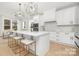 Contemporary kitchen with a large island, modern pendant lighting, white cabinetry, and stainless steel appliances at 3119 Shenandoah Ave, Charlotte, NC 28205