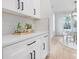Bright kitchen featuring white cabinets, modern backsplash, and countertops, complemented by light hardwood floors at 3119 Shenandoah Ave, Charlotte, NC 28205