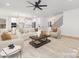 Bright, open-concept living room featuring hardwood floors, modern lighting, and stylish neutral-toned furniture at 3119 Shenandoah Ave, Charlotte, NC 28205