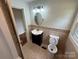 Bathroom featuring a vanity, toilet, and tile accents at 322 Buffalo St, Shelby, NC 28150