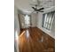 Sun-filled bedroom with polished hardwood floors, neutral walls, a ceiling fan, and sunlit windows at 322 Buffalo St, Shelby, NC 28150
