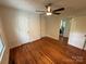 Bedroom featuring hardwood floors with multiple windows and doors at 322 Buffalo St, Shelby, NC 28150