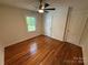 Bright bedroom with hardwood floors, neutral walls, and a ceiling fan at 322 Buffalo St, Shelby, NC 28150