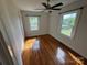 Bedroom featuring hardwood floors, a ceiling fan, and natural light from multiple windows at 322 Buffalo St, Shelby, NC 28150