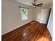 Bedroom featuring hardwood floors, a ceiling fan, and natural light from a window at 322 Buffalo St, Shelby, NC 28150
