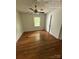 Bright bedroom featuring natural hardwood flooring, neutral walls, and natural light from the window at 322 Buffalo St, Shelby, NC 28150