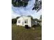 Side view of home featuring white siding, dark shutters, green grass, and air conditioning unit at 322 Buffalo St, Shelby, NC 28150