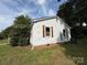View of the side exterior of the property featuring brick base, shutters, and light-colored siding at 322 Buffalo St, Shelby, NC 28150