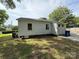 Rear view of the property featuring a well-kept lawn, windows, and a light-colored exterior at 322 Buffalo St, Shelby, NC 28150