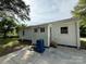 Rear exterior of the property featuring a concrete patio, an entry door, and a light-colored exterior at 322 Buffalo St, Shelby, NC 28150
