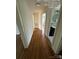 Inviting hallway with hardwood floors, leading to rooms with bright, neutral walls and natural light at 322 Buffalo St, Shelby, NC 28150
