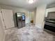 Updated kitchen with stainless steel refrigerator, white cabinets, modern countertops, and new appliances at 322 Buffalo St, Shelby, NC 28150
