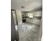 Modern kitchen with white cabinets, stainless steel appliances, and stylish tile flooring at 322 Buffalo St, Shelby, NC 28150