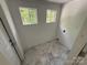 Dedicated laundry room features tile flooring, bright paint and two windows at 322 Buffalo St, Shelby, NC 28150