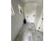 Practical laundry area with gray tile flooring, white walls, and window, ready for appliances at 322 Buffalo St, Shelby, NC 28150