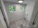 Dedicated laundry room features tile flooring, bright paint and two windows at 322 Buffalo St, Shelby, NC 28150