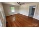 Bright living room with hardwood floors, ceiling fan, and ample natural light through windows at 322 Buffalo St, Shelby, NC 28150