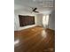 Bright living room featuring hardwood floors, a ceiling fan, and lots of natural light from the windows at 322 Buffalo St, Shelby, NC 28150