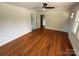 Bright living room with hardwood floors, ceiling fan, and ample natural light through windows at 322 Buffalo St, Shelby, NC 28150