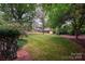 Lush backyard with mature trees and a manicured lawn at 3221 5Th Street Nw Ct, Hickory, NC 28601