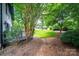 Lush backyard with mature trees and a manicured lawn at 3221 5Th Street Nw Ct, Hickory, NC 28601