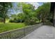 Backyard features a gray deck and lush green landscaping at 3221 5Th Street Nw Ct, Hickory, NC 28601