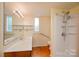 Bright bathroom with vanity, accessible shower and striped wallpaper at 3221 5Th Street Nw Ct, Hickory, NC 28601
