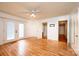 A bedroom with double doors to the exterior, a fan, and two doorways at 3221 5Th Street Nw Ct, Hickory, NC 28601