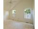 Spacious bedroom with vaulted ceiling and natural light from the two windows with shutters at 3221 5Th Street Nw Ct, Hickory, NC 28601