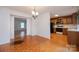 Dining area connecting to the kitchen and another room; hardwood floors, light fixture at 3221 5Th Street Nw Ct, Hickory, NC 28601