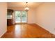 Well-lit dining area with hardwood floors and access to a back deck through sliding glass doors at 3221 5Th Street Nw Ct, Hickory, NC 28601
