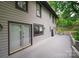 Exterior view showcasing a light gray home with a spacious gray deck and dark trim at 3221 5Th Street Nw Ct, Hickory, NC 28601