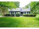 Charming single-Gathering home featuring lush landscaping and a well-manicured lawn at 3221 5Th Street Nw Ct, Hickory, NC 28601