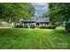 Charming home with lush front lawn, mature trees, and manicured shrubbery creating lovely curb appeal at 3221 5Th Street Nw Ct, Hickory, NC 28601
