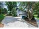 Detached garage with a driveway, surrounded by mature trees offering shade and privacy at 3221 5Th Street Nw Ct, Hickory, NC 28601