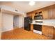 A full kitchen view with wooden cabinetry, black appliances, and wallpaper at 3221 5Th Street Nw Ct, Hickory, NC 28601