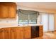 A sink and counter area with wooden cabinets and a view to the exterior at 3221 5Th Street Nw Ct, Hickory, NC 28601