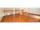 Spacious living room with hardwood floors, a wooden banister, and plenty of natural light at 3221 5Th Street Nw Ct, Hickory, NC 28601