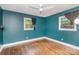 Bright bedroom featuring hardwood floors, natural light from two windows and a ceiling fan at 3230 Kingsfield Rd, Rock Hill, SC 29732