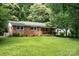Charming brick ranch-style home with a well-manicured lawn and lush landscaping at 3230 Kingsfield Rd, Rock Hill, SC 29732