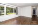 Bright living room featuring hardwood floors, a large window, and a white front door at 3230 Kingsfield Rd, Rock Hill, SC 29732